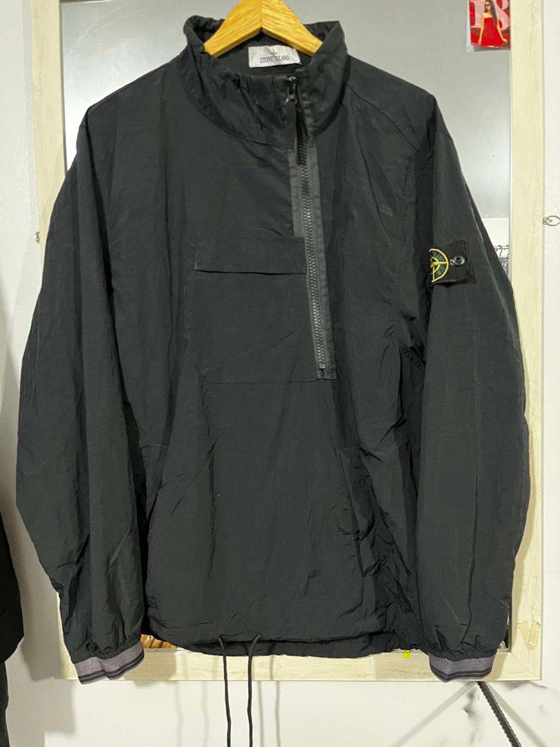 Stone Island Black Anorak Jacket Size L (Category: Coats, Jackets and Outerwear) located in Cabuyao City. Submitted by undergroundthrift03 (Listing ID 1466319334, Image 1). Description: Black Stone Island anorak jacket in size large. Half-zip front closure with a chest pocket and drawstring hem. Classic compass badge on the left sleeve. Ribbed cuffs with grey striped detailing. Certilogo authentication tag attached inside with code visible. Light