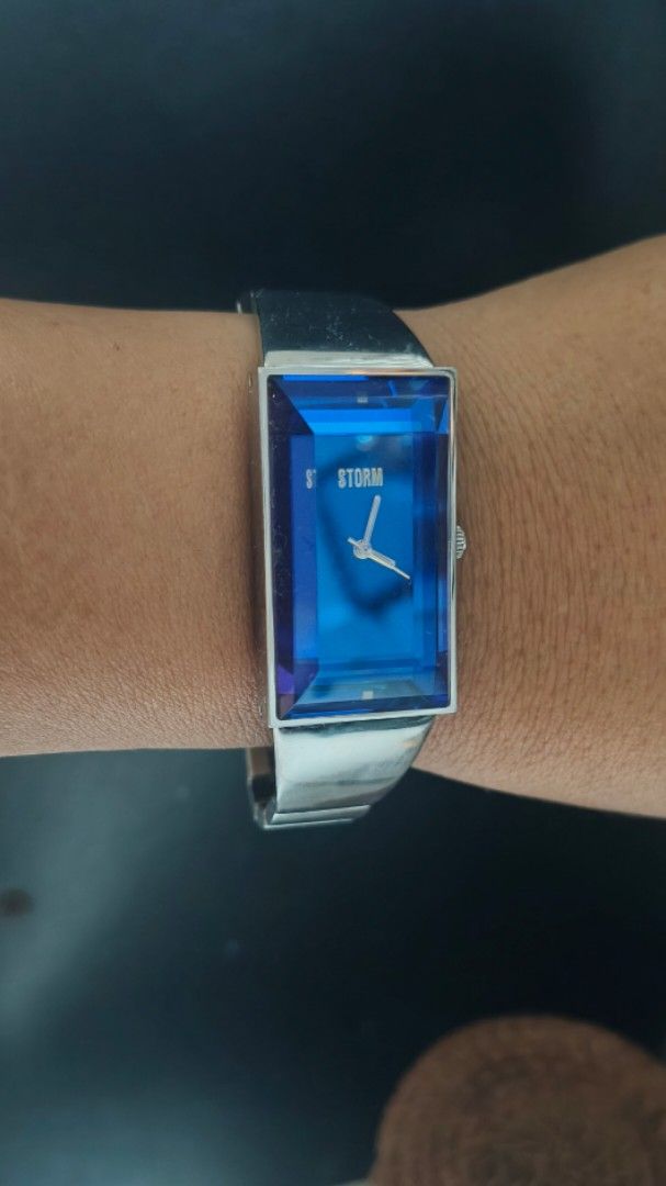 Storm London Blue Crystal Rectangular Watch (Category: Women's Watches) located in Taguig. Submitted by mercyeugen28914 (Listing ID 1466298572, Image 1). Description: - Brand: Storm London - Dial: Striking blue faceted crystal face with minimal silver hands and logo - Case & Strap: Rectangular silver-tone metal case with a linked stainless steel bracelet - Design: Futuristic style that catches the light from every angle - Fit: Comfortable and adj