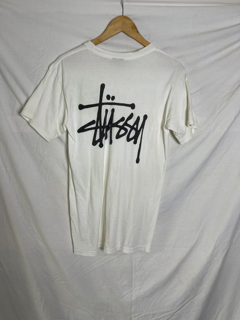 Stüssy White Graphic Tee (Category: Tshirts & Polo Shirts ) located in Manila. Submitted by japee55 (Listing ID 1466320941, Image 2). Description: - Brand: Stüssy - Color: White with black prints - Size: Small - Material: 100% Cotton (Made in Mexico) - Design: Small left chest logo and large signature back graphic - Fit: Standard crew neckline with short sleeves - Condition: Brand new / Excellent.