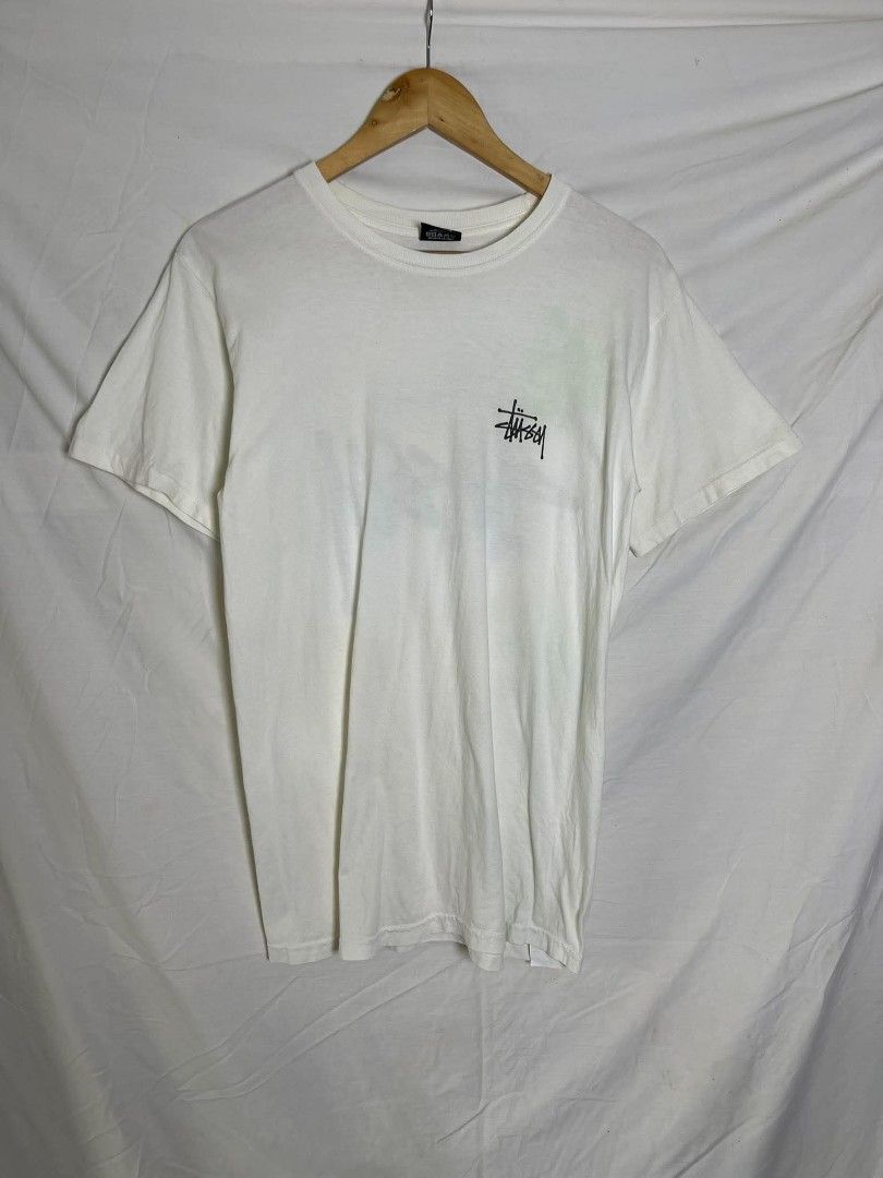 Stüssy White Graphic Tee (Category: Tshirts & Polo Shirts ) located in Manila. Submitted by japee55 (Listing ID 1466320941, Image 1). Description: - Brand: Stüssy - Color: White with black prints - Size: Small - Material: 100% Cotton (Made in Mexico) - Design: Small left chest logo and large signature back graphic - Fit: Standard crew neckline with short sleeves - Condition: Brand new / Excellent.
