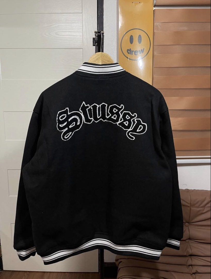 Stussy Black Varsity Jacket (Category: Coats, Jackets and Outerwear) located in Cainta. Submitted by tinpalma (Listing ID 1466307054, Image 2). Description: - Brand: Stussy - Condition: Brand new with tags (BNWT) - Color: Black with white embroidery on chest and back - Size: XL - Details: Striped ribbing on collar, cuffs, and hem, button-up front, and functional side pockets.