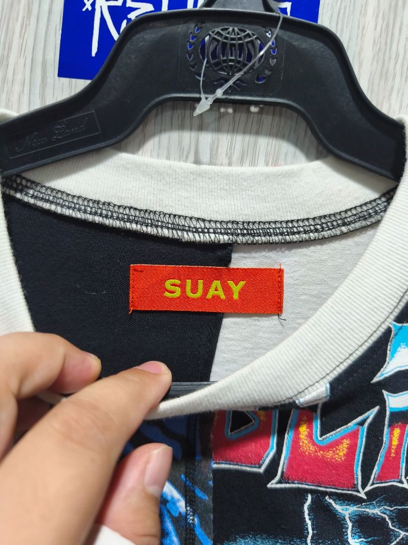 SUAY Upcycled Patchwork Graphic Tee 1/1 (Category: Tshirts & Polo Shirts ) located in Davao. Submitted by thethriftproject082 (Listing ID 1466304154, Image 3). Description: - Brand/Model: SUAY Patchwork Short Sleeve T-Shirt - Design: Multicolor panels with bold graphic prints including Jason Voorhees hockey mask, Blink-182 typography, and tour dates - Details: Ribbed collar, contrast stitching, and distinctive orange neck tag with yellow SUAY log