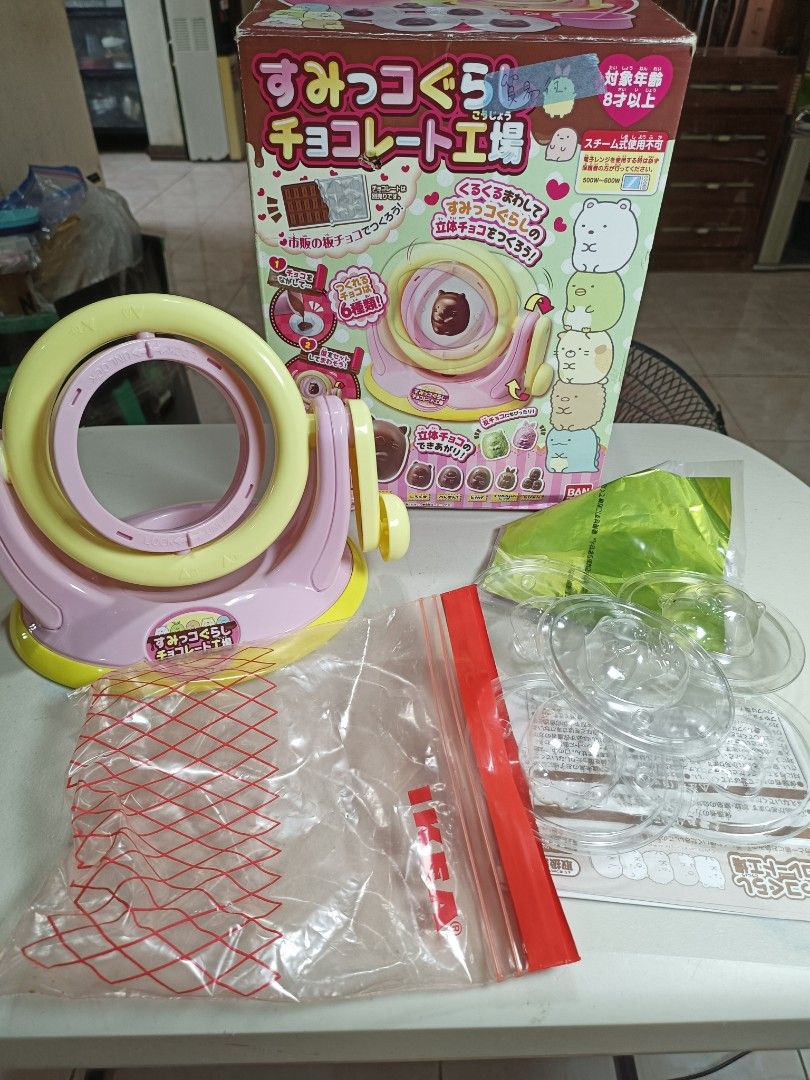 Sumikkogurashi Chocolate Factory Maker Toy Set (Category: Designer & Blind Box Toys) located in Bacoor. Submitted by cheriejolieph (Listing ID 1466181471, Image 2). Description: - Official Bandai Sumikkogurashi chocolate making kit - Easily make adorable 3D character chocolates using ordinary chocolate bars - Includes pink spinner machine, molds, cup, and wrapping materials - Comes in original box, missing cup 1 ,pc.moulder and stick - Perfect fu