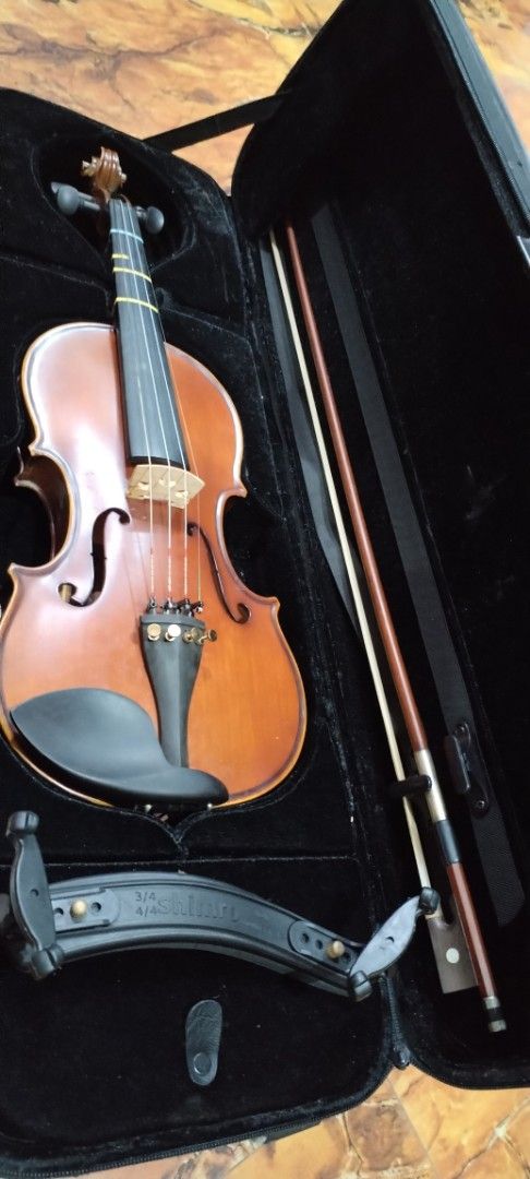 Suzuki 3/4 Violin with Case, Bow and Shoulder Rest (Category: Musical Instruments) located in Caloocan City. Submitted by rowely_jpn (Listing ID 1466286738, Image 1). Description: - Suzuki 3/4 size violin set, perfect for students and lessons - Features clean wood body, standard tailpiece, and four fine tuners - Fingerboard equipped with intonation tape guides for easy learning - Includes durable hardshell case for safe transport - Comes with bow