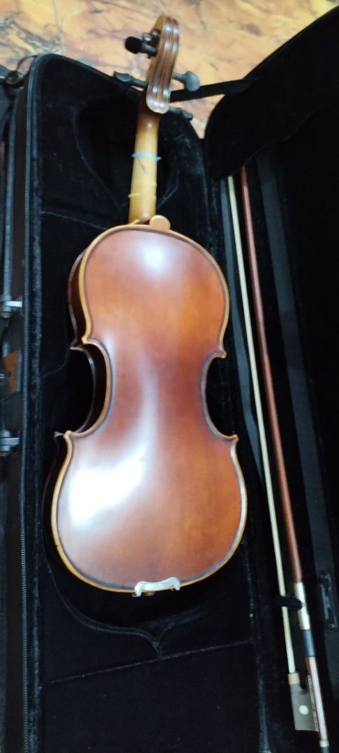 Suzuki 3/4 Violin with Case, Bow and Shoulder Rest (Category: Musical Instruments) located in Caloocan City. Submitted by rowely_jpn (Listing ID 1466286738, Image 2). Description: - Suzuki 3/4 size violin set, perfect for students and lessons - Features clean wood body, standard tailpiece, and four fine tuners - Fingerboard equipped with intonation tape guides for easy learning - Includes durable hardshell case for safe transport - Comes with bow
