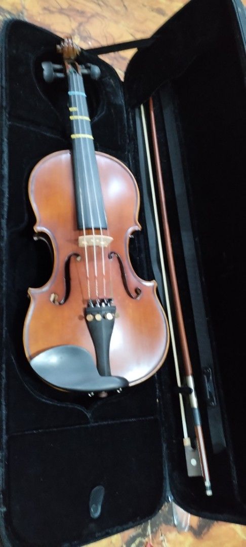 Suzuki 3/4 Violin with Case, Bow and Shoulder Rest (Category: Musical Instruments) located in Caloocan City. Submitted by rowely_jpn (Listing ID 1466286738, Image 3). Description: - Suzuki 3/4 size violin set, perfect for students and lessons - Features clean wood body, standard tailpiece, and four fine tuners - Fingerboard equipped with intonation tape guides for easy learning - Includes durable hardshell case for safe transport - Comes with bow