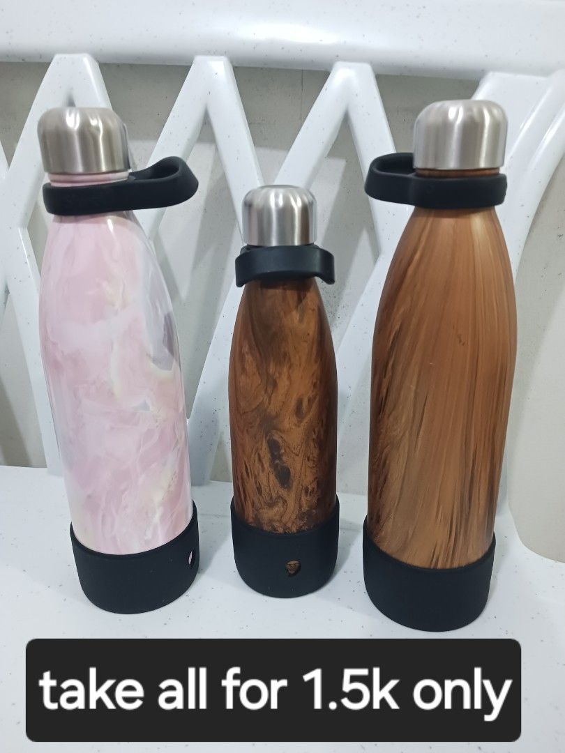 S'well Stainless Steel Water Bottles Bundle Set (Category: Water Bottles & Tumblers) located in Taguig. Submitted by l.a.8 (Listing ID 1466220339, Image 1). Description: - Set of 3 S'well insulated water bottles (Bundle deal) - Capacity: 25oz / 750 ml and 17oz / 500ml - Designs: 1 Pink Marble and 2 Wood Grain finishes - Extras included: Black silicone protective boots and matching black cap carrying loops - Care instructions: Hand wash only - Pri