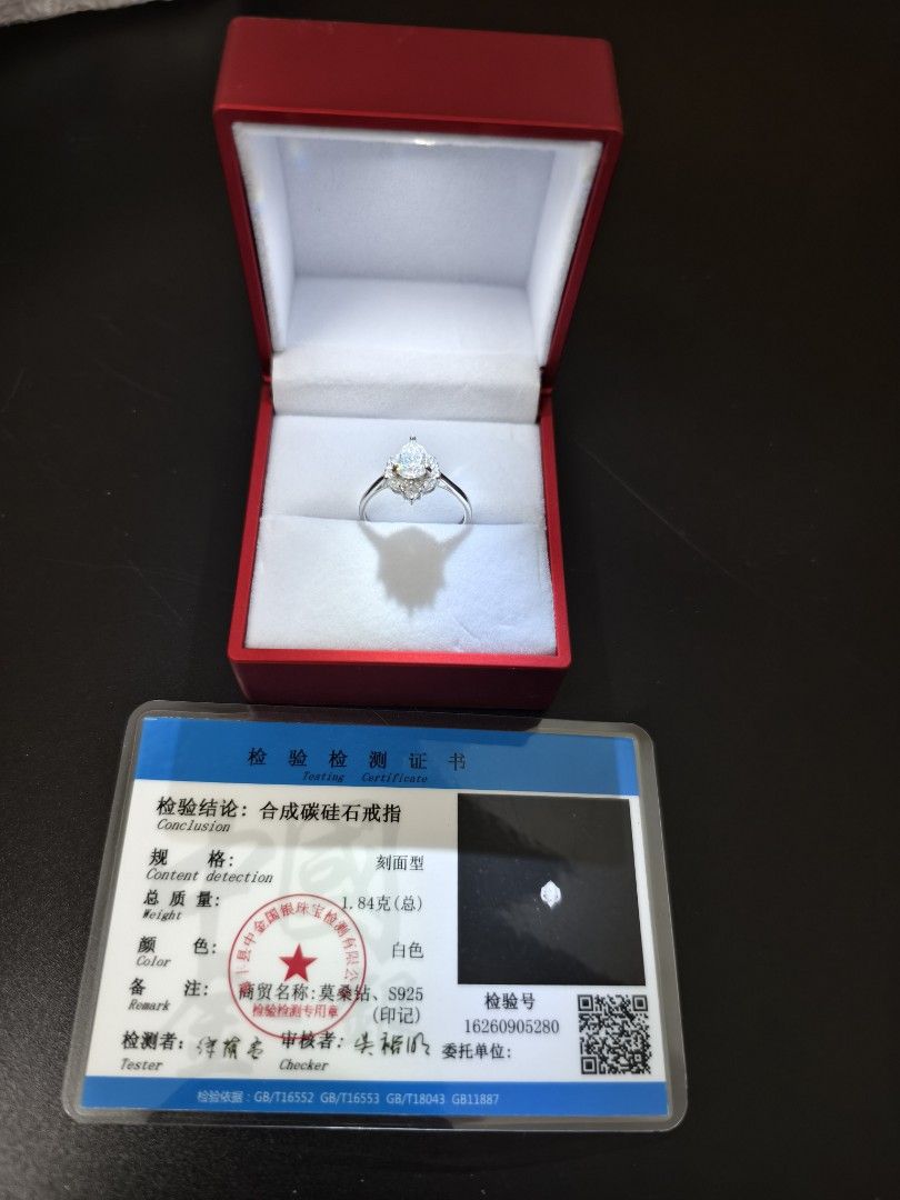 Synthetic Moissanite S925 Silver Ring with Testing Certificate (Category: Rings) located in Angeles City. Submitted by measaliman02351 (Listing ID 1466225551, Image 2). Description: - Main Stone: Synthetic carbon silicon pear-cut stone with dazzling side stones - Metal: S925 stamped sterling silver - Total Weight: 1.84 grams - Color: Elegant white - Certification: Includes official testing certificate (ID: 16260905280) - Packaging: Comes in a pre