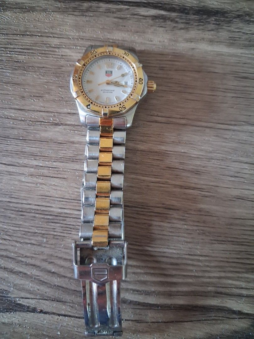 TAG Heuer 2000 Professional Two-Tone Watch (Category: Luxury Watches) located in Manila. Submitted by dragonseller2026 (Listing ID 1466159011, Image 1). Description: - Brand: TAG Heuer 2000 Professional (Women's size) - Movement: Quartz (battery-powered), keeps time accurately - Dial: White dial with gold hands, markers, and date display at 3 o'clock - Bezel: Rotating bezel with gold numerals - Strap: Two-tone stainless steel and gold bracelet wi