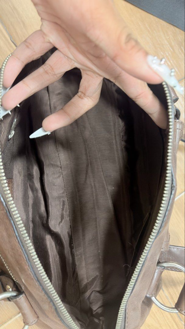 Tefu Tefu Brown Shoulder Bag (Category: Shoulder Bags) located in Manila. Submitted by serraphimav (Listing ID 1466291844, Image 3). Description: - Brand: Tefu Tefu - Material: Brown leather-look - Closure: Secure top zip - Pockets: Front pocket with flap, interior zip pocket - Details: Silver tone hardware and edgy stud accents on the straps - Interior: Clean brown fabric lining with stitched brand label - Condition: Impeccably clean inside and 