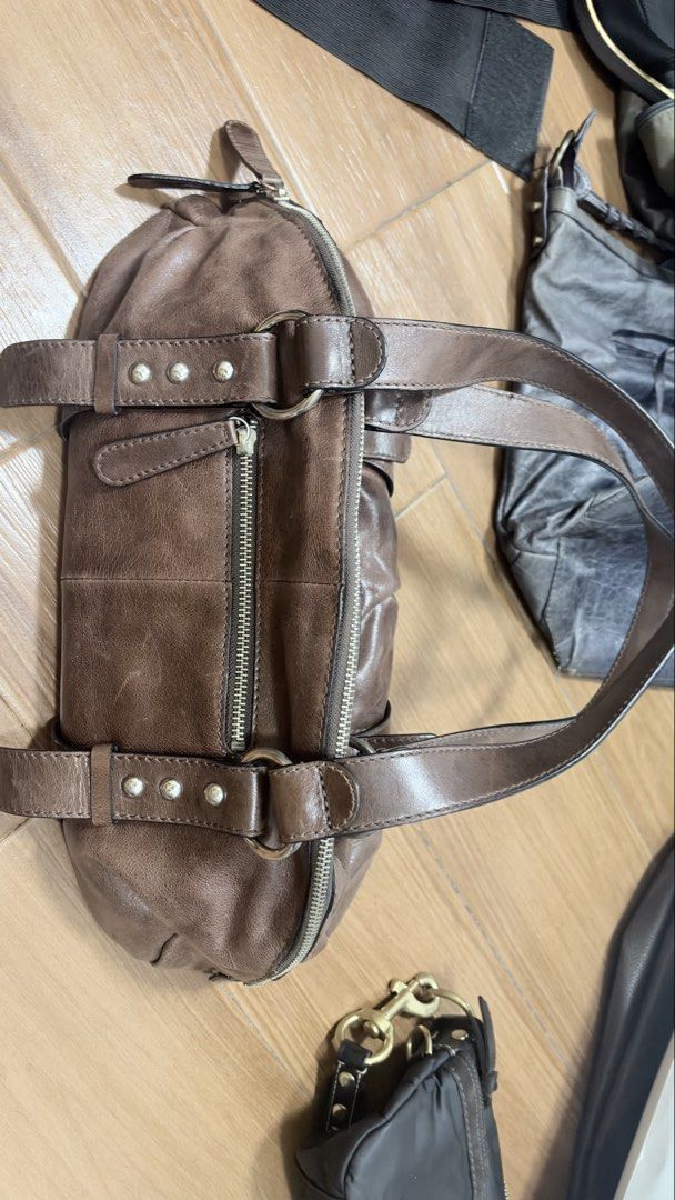 Tefu Tefu Brown Shoulder Bag (Category: Shoulder Bags) located in Manila. Submitted by serraphimav (Listing ID 1466291844, Image 2). Description: - Brand: Tefu Tefu - Material: Brown leather-look - Closure: Secure top zip - Pockets: Front pocket with flap, interior zip pocket - Details: Silver tone hardware and edgy stud accents on the straps - Interior: Clean brown fabric lining with stitched brand label - Condition: Impeccably clean inside and 