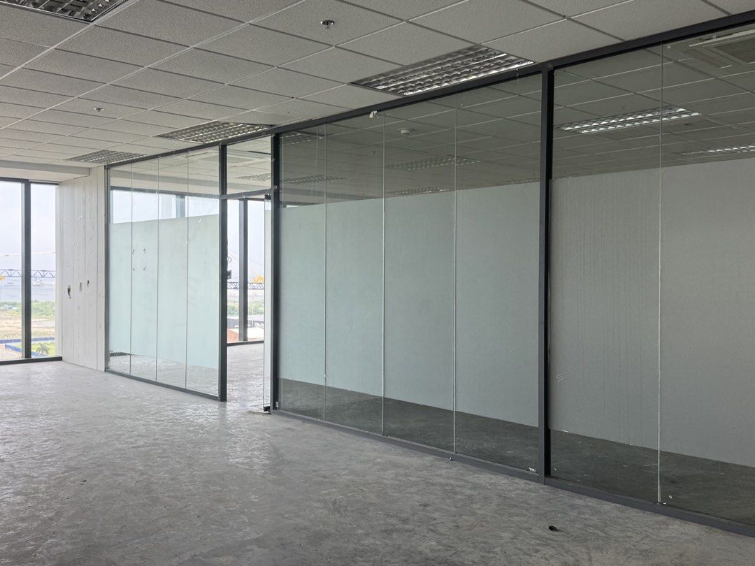 Tempered Glass Office Partition Wall (Category: Office Furniture & Fixtures) located in Manila. Submitted by marquezpa52205 (Listing ID 1466213230, Image 3). Description: - Type: Frameless glass panels with black metal framing - Features: Frosted privacy film in the middle section, glass doors with metal handles - Ideal for: Modern workspace or meeting room dividers - Condition: Solid condition - Logistics: Dismantling and transport to be arrange