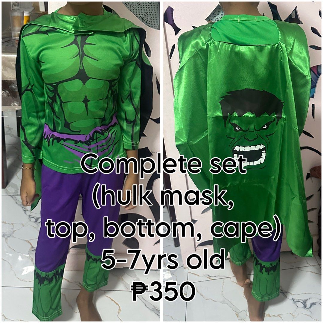 The Hulk Costume Set halloween (Category: Babies & Kids Fashion) located in Manila. Submitted by jentistwah (Listing ID 1466186510, Image 1). Description: Complete Hulk superhero costume for kids aged 5 to 7 years old. Package includes a green mask, muscle-print long sleeve top, matching purple pants with green hem details, and a green cape featuring a large Hulk graphic on the back. Made from lightweight costume material. Great option for partie