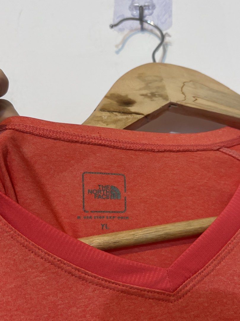 The North Face Drifit Shirt (Category: Shirts) located in Bulacan. Submitted by janeeeeelleeeee (Listing ID 1466188009, Image 3). Description: - Brand: The North Face - Color: Coral pink with contrasting side panels - Size: YL (Youth Large / fits petite adults) - Neckline: V-neck - Material: Lightweight and breathable - Ideal for: Workouts, running, and active wear - Condition: Excellent.