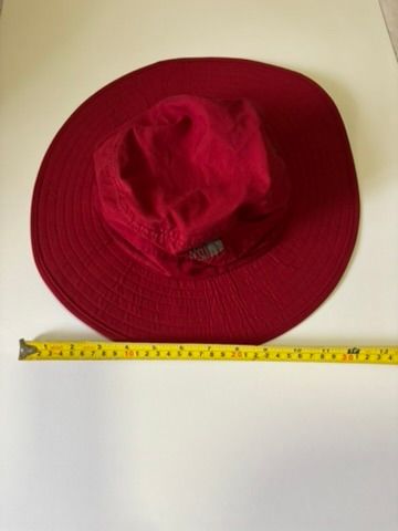 The North Face Sun Hat Red (Category: Caps & Hats) located in Quezon City. Submitted by leahs.stuff (Listing ID 1466213610, Image 1). Description: - Brand: The North Face - Color: Red top with grey inner lining - Features: Adjustable chin strap with toggle cord lock for a secure fit - Comfort: Black sweatband lining along the interior - Condition: Clean fabric, ready to wear - Ideal for: Outdoor hiking, camping, beach trips, and everyday sun prot
