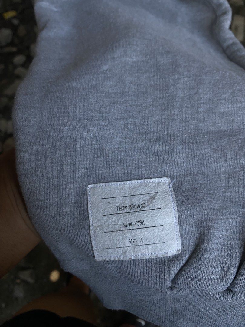Thom Browne New York Grey Sweatpants Size 2 (Category: Joggers) located in San Fernando. Submitted by thrifteezy6 (Listing ID 1466204196, Image 2). Description: - Brand: Thom Browne New York - Size: 2 (Made in Japan) - Color: Grey with signature white 4-bar stripes on the left leg - Material: Premium fleece for ultimate daily comfort - Details: Drawstring waist with silver hardware, woven lower leg size tag, and iconic red, white, and blue grosgr
