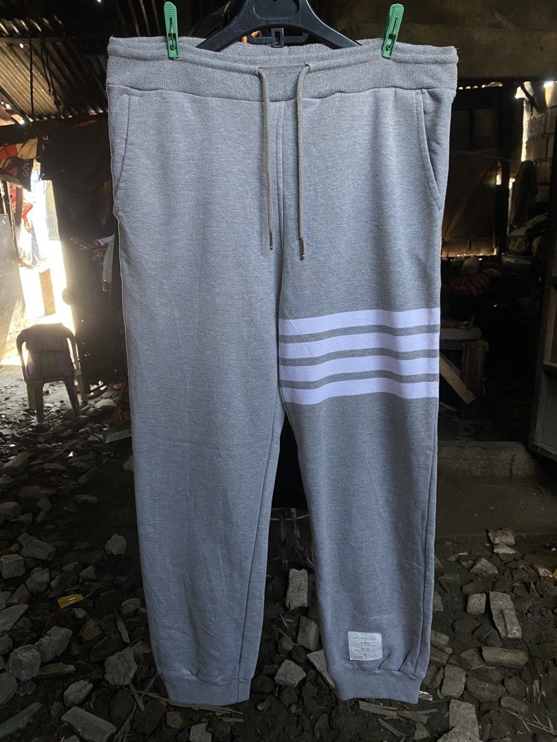 Thom Browne New York Grey Sweatpants Size 2 (Category: Joggers) located in San Fernando. Submitted by thrifteezy6 (Listing ID 1466204196, Image 1). Description: - Brand: Thom Browne New York - Size: 2 (Made in Japan) - Color: Grey with signature white 4-bar stripes on the left leg - Material: Premium fleece for ultimate daily comfort - Details: Drawstring waist with silver hardware, woven lower leg size tag, and iconic red, white, and blue grosgr