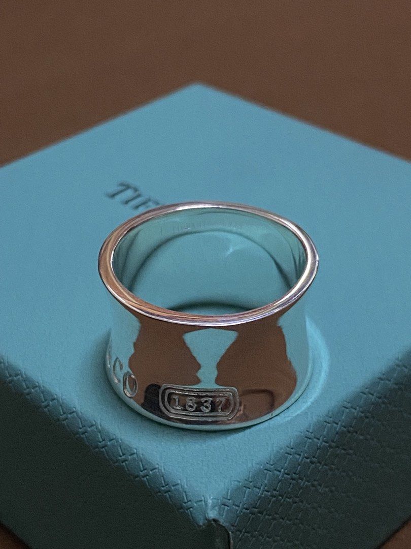 Tiffany & Co. 1837 Narrow Wide Maker Ring 925 Silver (Category: Rings) located in Manila. Submitted by xielega (Listing ID 1466332523, Image 2). Description: - Brand: Authentic Tiffany & Co. - Model: 1837 Ring - Material: Solid 925 sterling silver with polished finish - Design: Curved profile with T & Co. stamp, 925 hallmark, 1837 box logo, and interior signature engraving - Inclusions: Original turquoise presentation box with black velvet insert