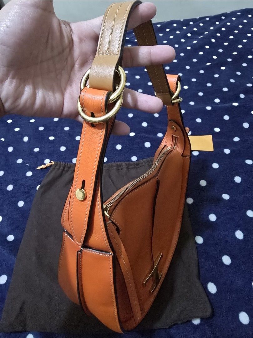 Tod's T Timeless Leather Orange Shoulder Bag (Category: Luxury Bags & Wallets) located in Pasig City. Submitted by litinpink (Listing ID 1466238654, Image 3). Description: - Brand: Tod's (Made in Italy) - Color: Bright orange with gold-tone hardware - Material: Premium leather - Style: Curved saddle shape with structured handle - Closure: Top zip closure - Interior: Clean lining with inner pocket and Tod's leather logo patch - Inclusions: Origina