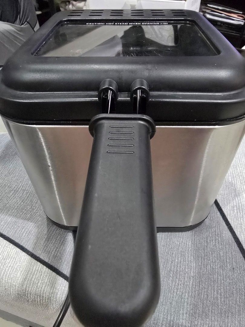 TOMLER 2.5L Electric Deep Fryer (Category: Fryers) located in Marikina City. Submitted by happy_haulsph (Listing ID 1466157881, Image 1). Description: - Brand: TOMLER - Capacity: 2.5L - Material: Silver stainless steel body with black lid and handle - Features: Adjustable temperature control knob and clear viewing window - Included: Inner metal mesh fry basket - Design: Compact size, ideal for kitchen countertops - Best for: Frying snacks, french