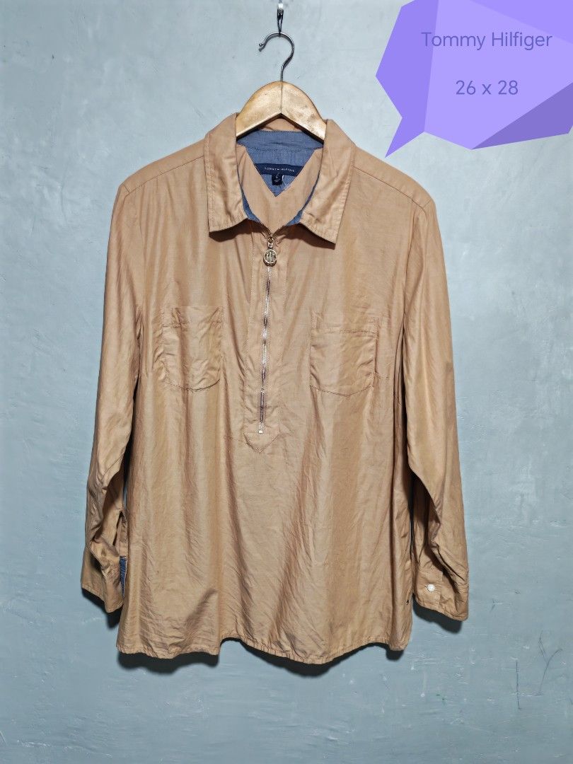 Tommy Hilfiger (Category: Longsleeves) located in Quezon City. Submitted by philjamesd0323 (Listing ID 1466159106, Image 1). Description: Preloved authentic Tommy Hilfiger half-zip popover tunic. Brand: Tommy Hilfiger Size: 1X (women's plus size) Color: Tan/khaki Style: Half-zip pullover, spread collar, two chest flap pockets Sleeves: Long, with roll-tab sleeves. Roll up to elbow length and button the tab to hold. Details: Blue chambray lining on