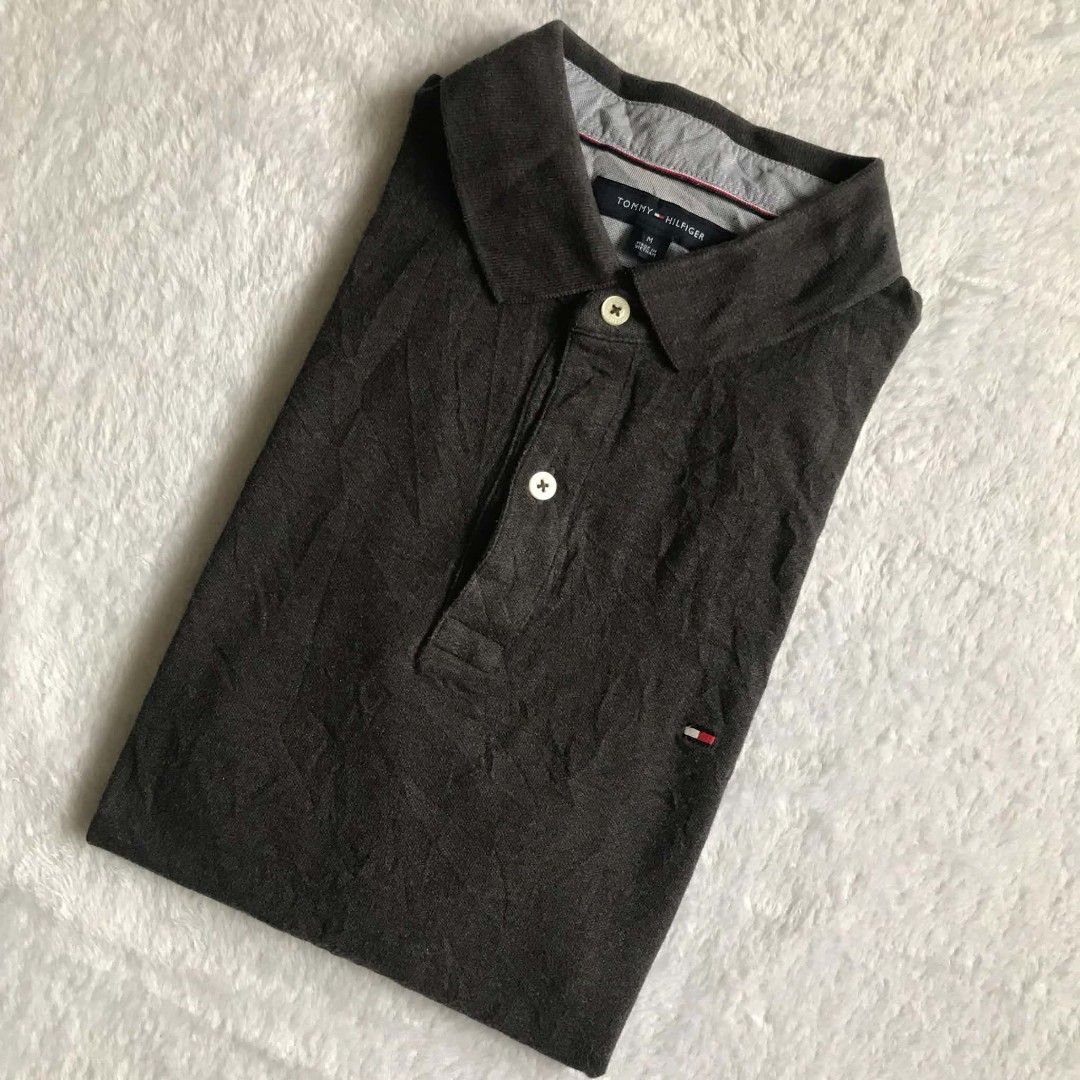 TOMMY HILFIGER SLIM FIT (Category: Activewear) located in Cebu City. Submitted by kevinthrift (Listing ID 1466292719, Image 2). Description: TOMMY HILFIGER POLO (CHARCOAL) Excellent Condition Size: Medium on tag Dimes:Length 27 | Width 20 Color rate: 9/10 ISSUE: neck fade pero di gaano fade Need wash.