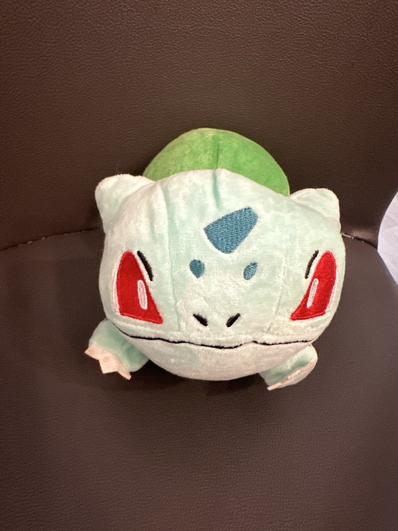TOMY Pokémon Bulbasaur Plush Toy (Category: Plushies & Soft Toys) located in Cainta. Submitted by shopbyyna (Listing ID 1466238288, Image 1). Description: - Brand: TOMY (Authentic) - Character: Bulbasaur - Condition: Excellent, clean fabric with original tag attached - Features: Embroidered face and back details, red eyes, soft mint green body - Size: Standard small plush - Perfect for: Pokémon fans and plushie collectors.
