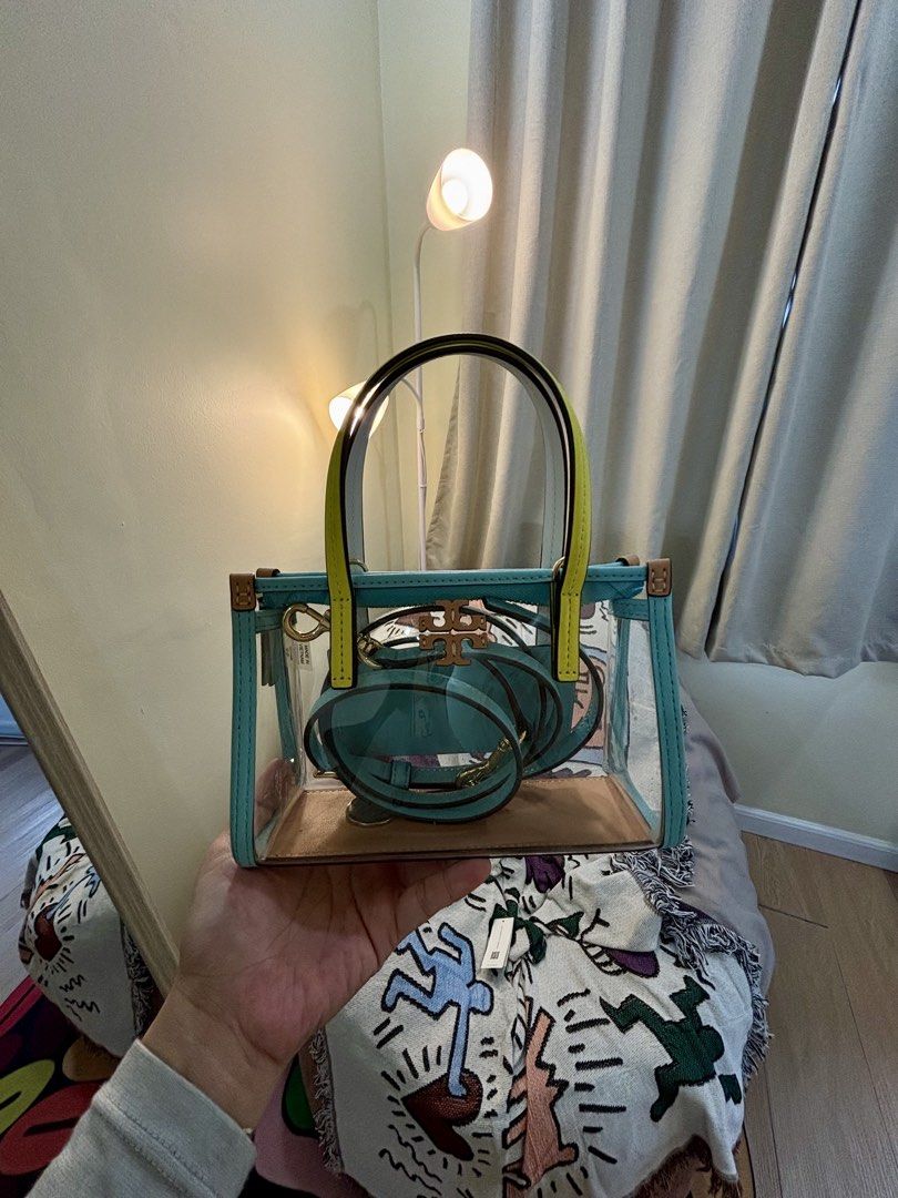 Preloved Tory Burch Blake Clear Mini Tote Bag (Category: Luxury Bags & Wallets) located in Naguilian. Submitted by MyJanuary (Listing ID 1466163744, Image 1). Description: - Preloved Tory Burch Blake Clear Mini Tote - 💯original - Colorway: Multi (Transparent PVC body, tan leather base, and contrast yellow top handles) - Hardware: Gold-tone - Strap: Detachable light blue leather crossbody strap - Condition: excellent condition - with its original