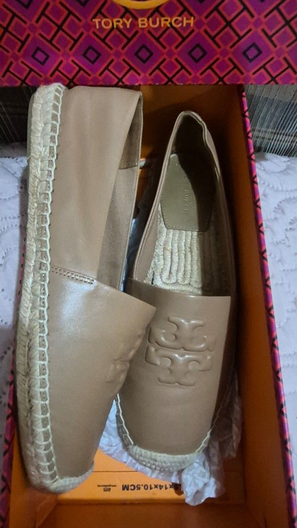 Tory Burch Leather Espadrilles Flat Shoes Tan Brown (Category: Flats & Sandals) located in Davao. Submitted by mommylove1422 (Listing ID 1466229321, Image 1). Description: - Authentic Tory Burch tan leather espadrilles - Features a stylish big embossed logo on top - Classic jute wrap around the midsole - Comfortable slip-on design with a flat rubber outsole - Condition: Clean overall with minimal wear on the soles - Includes original patterned bo
