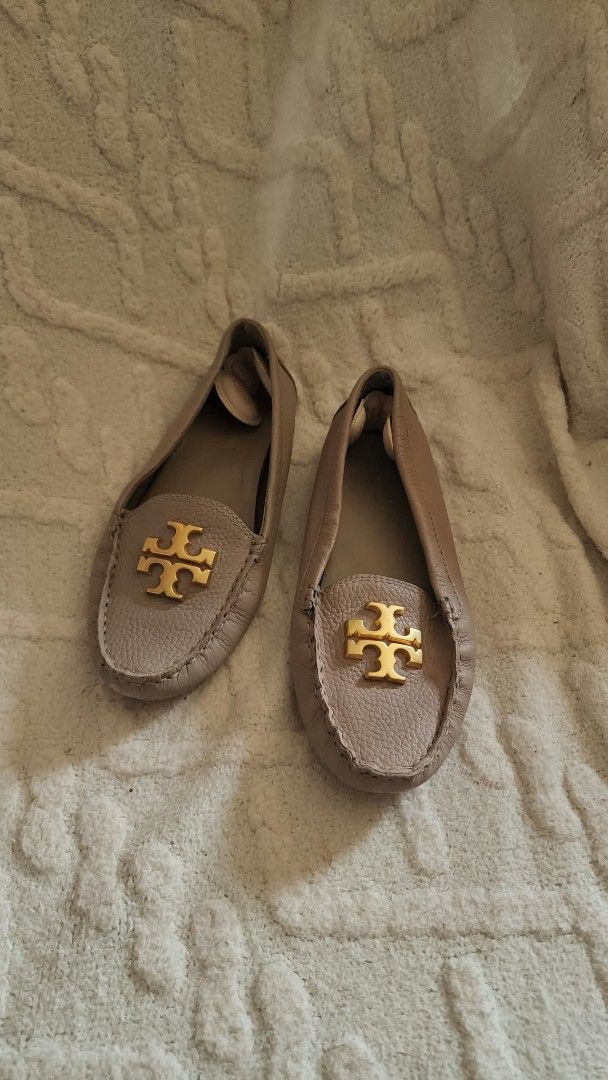 Tory Burch Leather Loafers Grey Gold Hardware (Category: Loafers) located in Lucena. Submitted by amirahsoonlineshop (Listing ID 1466171702, Image 3). Description: Authentic Tory Burch grey taupe leather driver loafers with gold hardware. Features pebbled leather, comfortable rubber pebble soles, and added heel grips. Shows minor wear on the insoles. Slip-on style, perfect for everyday chic wear..
