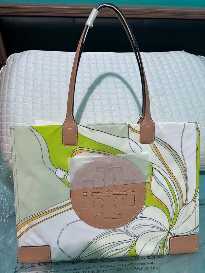 Tory Burch Tote Bag Green Tulip (Category: Tote Bags) located in Paranaque City. Submitted by crisnold2123 (Listing ID 1466174343, Image 3). Description: - Authentic Tory Burch tote in Green Tulip (Style: 88237, Color: 300) - Eye-catching large graphic floral print on durable nylon - Elegant tan leather handles and corner accents - Iconic circular logo medallion on front (still wrapped in protective plastic) -original i bought in South coast plaz