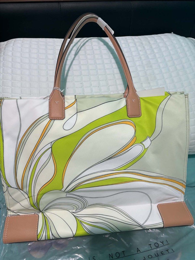Tory Burch Tote Bag Green Tulip (Category: Tote Bags) located in Paranaque City. Submitted by crisnold2123 (Listing ID 1466174343, Image 2). Description: - Authentic Tory Burch tote in Green Tulip (Style: 88237, Color: 300) - Eye-catching large graphic floral print on durable nylon - Elegant tan leather handles and corner accents - Iconic circular logo medallion on front (still wrapped in protective plastic) -original i bought in South coast plaz