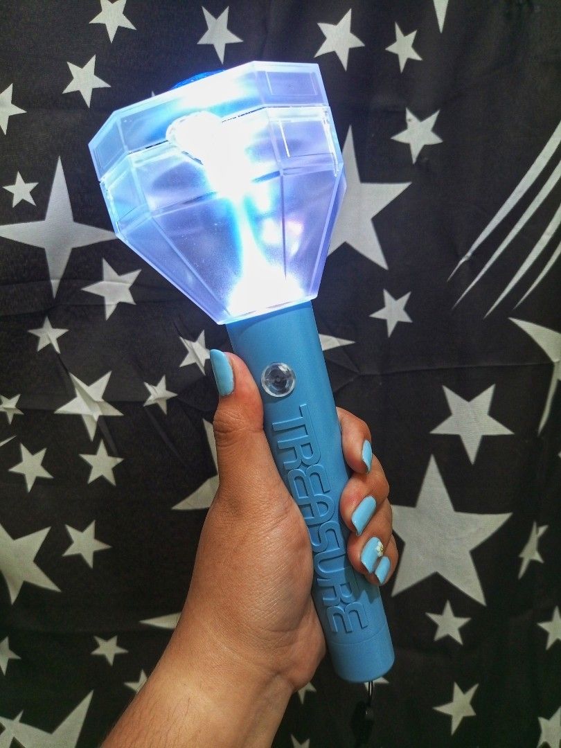 TREASURE Official Lightstick Teu-light (Category: Lighting) located in Manila. Submitted by mabautista1993 (Listing ID 1466253382, Image 1). Description: - Official TREASURE lightstick ver 2 in light blue - Features iconic gemstone top design and embossed handle lettering - Bright white LED light from clear plastic diamond head - Includes attached wrist strap for easy carrying - Ideal for concerts, fan meetings, and shelf display - Tested and wor