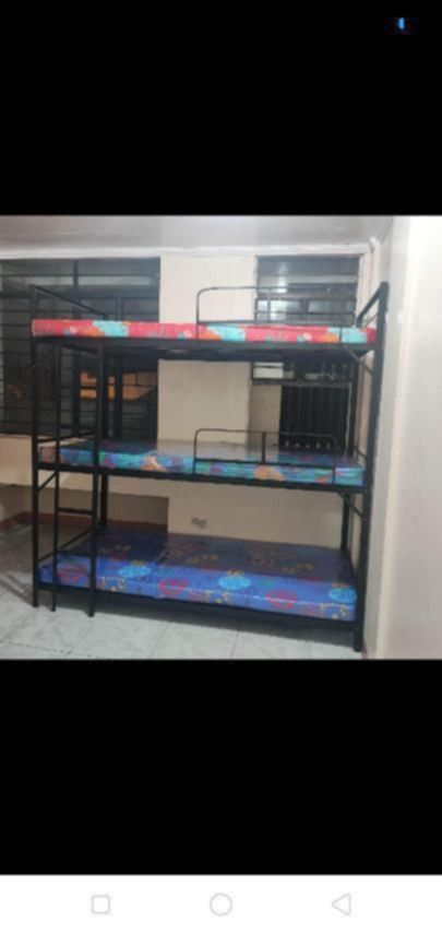 Triple Bunk Bed Frame with Mattresses (Category: Bed Frames & Mattresses) located in Manila. Submitted by eukris (Listing ID 1466187406, Image 1). Description: - Heavy-duty black metal triple decker bunk bed - Includes 3 matching mattresses with colorful patterned covers - Space-saving vertical design, ideal for dorms and guest rooms - Built-in ladder on the side for easy access - Safety rails included on top and middle bunks - Note: Buyer must h