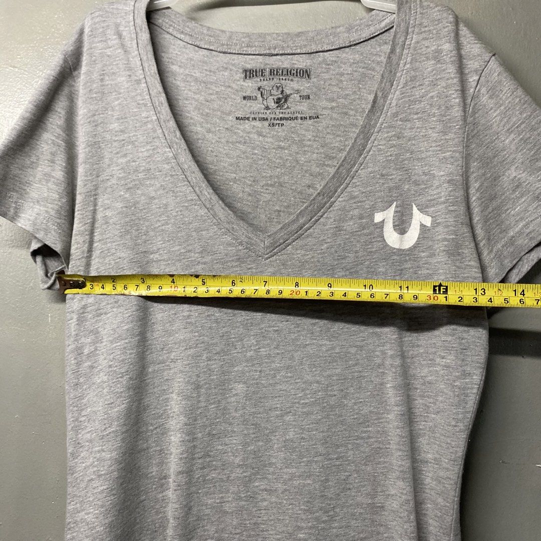 True Religion Grey V-Neck Tee with Logo (Category: Tshirts & Polo Shirts ) located in Cagayan de Oro. Submitted by sumamestreethub (Listing ID 1466247345, Image 3). Description: - Brand: True Religion - Color: Grey - Style: V-neck, short sleeves, classic fit - Detail: Small white horseshoe logo on left chest - Condition: Clean fabric, excellent basic piece for daily outfits.