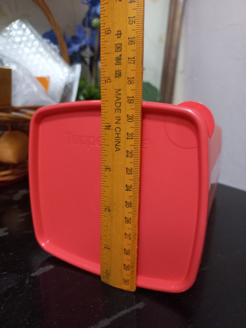 Tupperware pink rectangular storage container (Category: Food Organisation & Storage) located in Kota Bharu. Submitted by syanor26 (Listing ID 1466191877, Image 3). Description: orange Tupperware storage container with matching lid. Rectangular shape, roughly 18 cm long. Good for organizing pantry staples, snacks, or dry goods. Easy to stack in the cupboard. Solid plastic build with secure sealing lid. Clean interior..