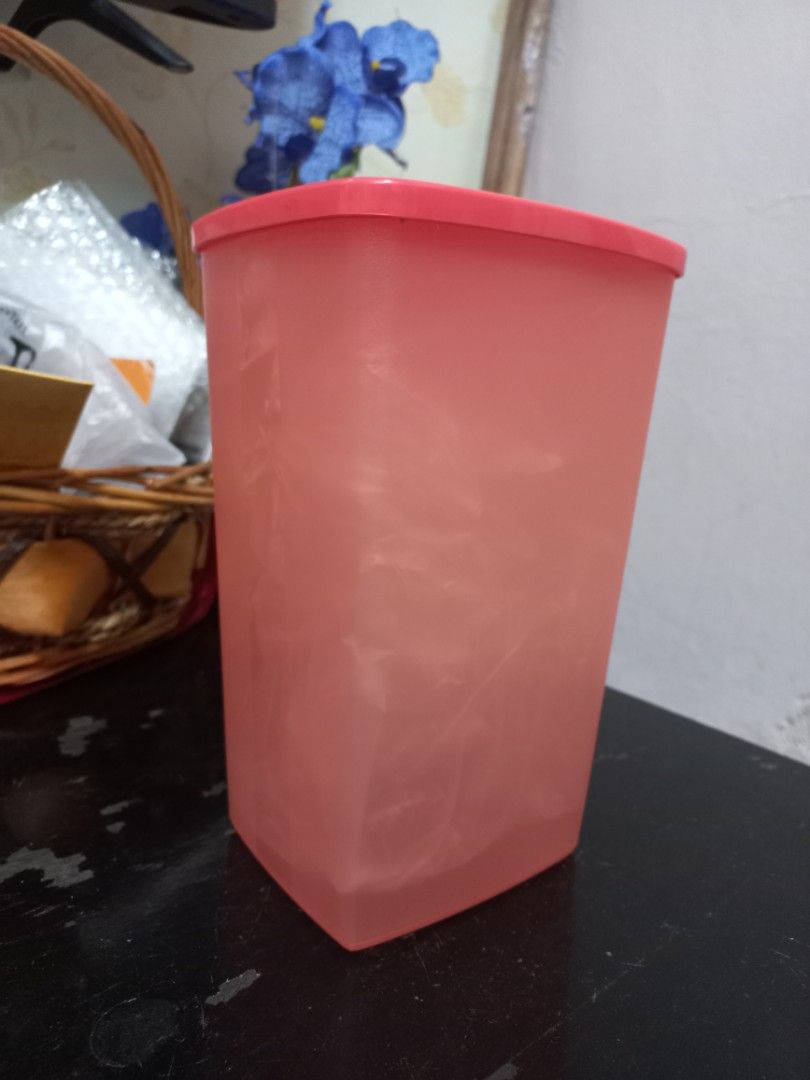 Tupperware pink rectangular storage container (Category: Food Organisation & Storage) located in Kota Bharu. Submitted by syanor26 (Listing ID 1466191877, Image 1). Description: orange Tupperware storage container with matching lid. Rectangular shape, roughly 18 cm long. Good for organizing pantry staples, snacks, or dry goods. Easy to stack in the cupboard. Solid plastic build with secure sealing lid. Clean interior..