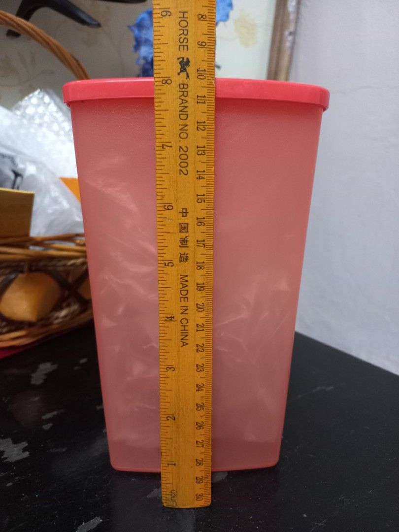 Tupperware pink rectangular storage container (Category: Food Organisation & Storage) located in Kota Bharu. Submitted by syanor26 (Listing ID 1466191877, Image 2). Description: orange Tupperware storage container with matching lid. Rectangular shape, roughly 18 cm long. Good for organizing pantry staples, snacks, or dry goods. Easy to stack in the cupboard. Solid plastic build with secure sealing lid. Clean interior..