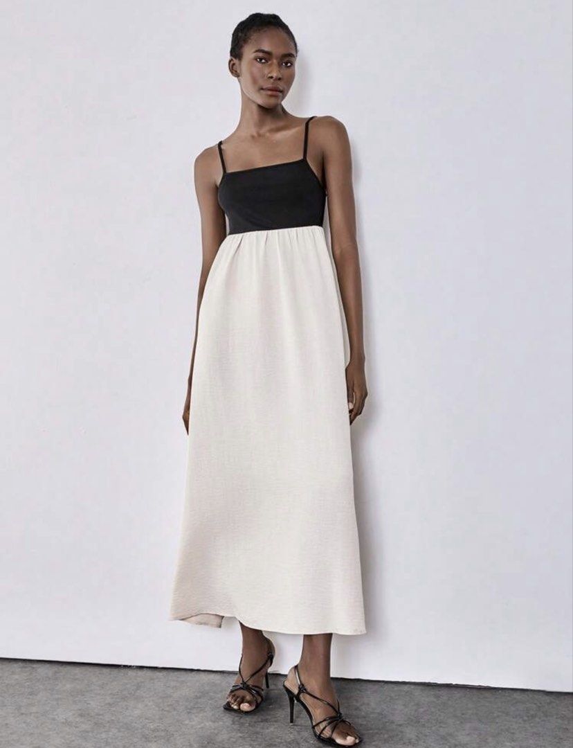 Two-tone Spaghetti Strap Maxi Dress Black Cream (Category: Dresses) located in Pasig City. Submitted by kutleyn (Listing ID 1466263663, Image 1). Description: - Color: Black bodice with a cream maxi skirt - Design: Spaghetti straps, fitted top, and flowy bottom - Versatility: Clean look, perfect for styling for various occasions - Condition: Brand new and ready to wear.