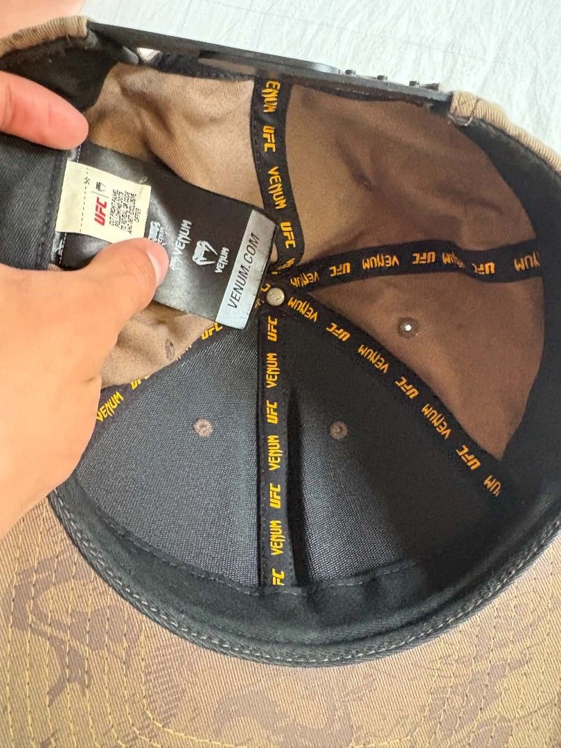 UFC Venum Snapback Cap (Category: Caps & Hats) located in Manila. Submitted by markjonesa54471 (Listing ID 1466188239, Image 2). Description: - Authentic UFC Venum snapback cap in brown camo - ISSUE LAST PIC - Eye-catching yellow embroidered Venum logo and side text - Adjustable black plastic strap for a custom fit - Original sticker still attached on the brim - Clean interior with branded seam tape.