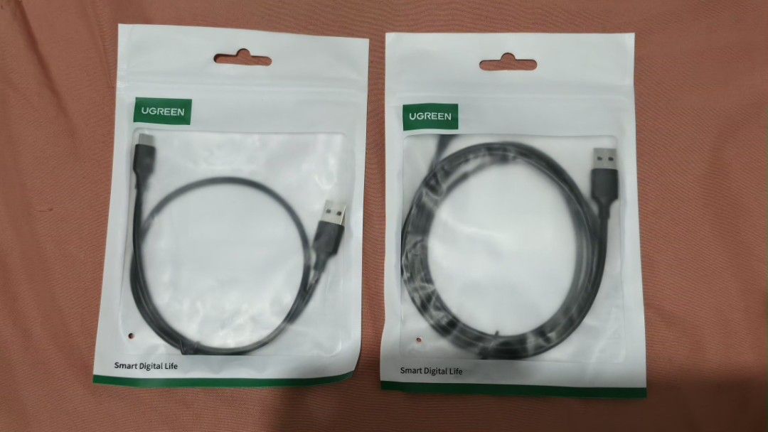 UGREEN USB-A to USB-C Cable 0.5m & 1.5m (Category: Cables & Adaptors) located in Manila. Submitted by cheolbinsart (Listing ID 1466300393, Image 1). Description: - Brand: UGREEN - Type: USB-A 2.0 to USB-C charging cables - Color: Black with nickel plating - Bundle includes: - 1x 0.5-meter cable (Model: US287, PN: 60115) - 1.5-meter cable (Model: US287, PN: 60117) - Condition: Brand new, factory-sealed in original packaging with barcodes (NEVER US