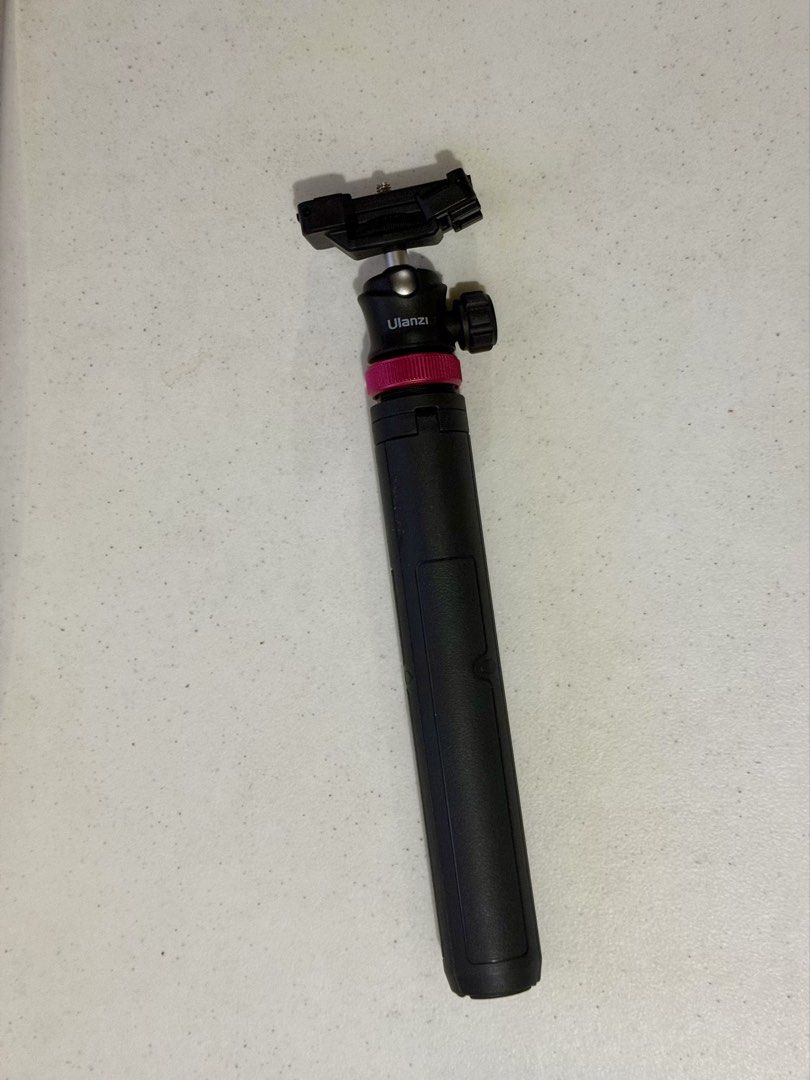 Ulanzi MT-08 Extendable Vlog Tripod (Category: Tripods & Monopods) located in Makati City. Submitted by louisells (Listing ID 1466184039, Image 1). Description: - Brand: Ulanzi - Color: Black with a vibrant pink accent ring below the ball head - 2-in-1 Design: Functions as both a mini tripod and a handheld selfie stick - Built-in Phone Clamp: Includes an integrated phone mount with a cold shoe slot on top for accessories - Standard Mount: Feature