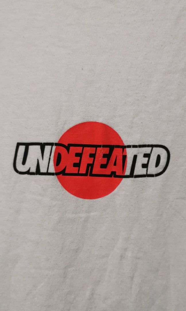 Undefeated white graphic tee (Category: Tshirts & Polo Shirts ) located in San Jose. Submitted by thrift_ni_sir (Listing ID 1466162630, Image 2). Description: Large on tag MOP gcash MOD j&t Add shipping fee.