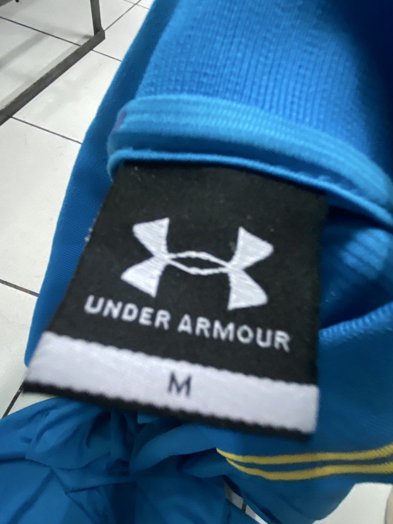 Under Armour Blue Polo Shirt Size M (Category: Tshirts & Polo Shirts ) located in Manila. Submitted by ariane0422 (Listing ID 1466257953, Image 2). Description: - Brand: Under Armour - Size: Men's Medium - Color: Bright blue with contrast yellow collar and logo details - Material: Breathable athletic fabric - Design: Short sleeve, button-front polo - Condition: Clean, excellent overall condition.
