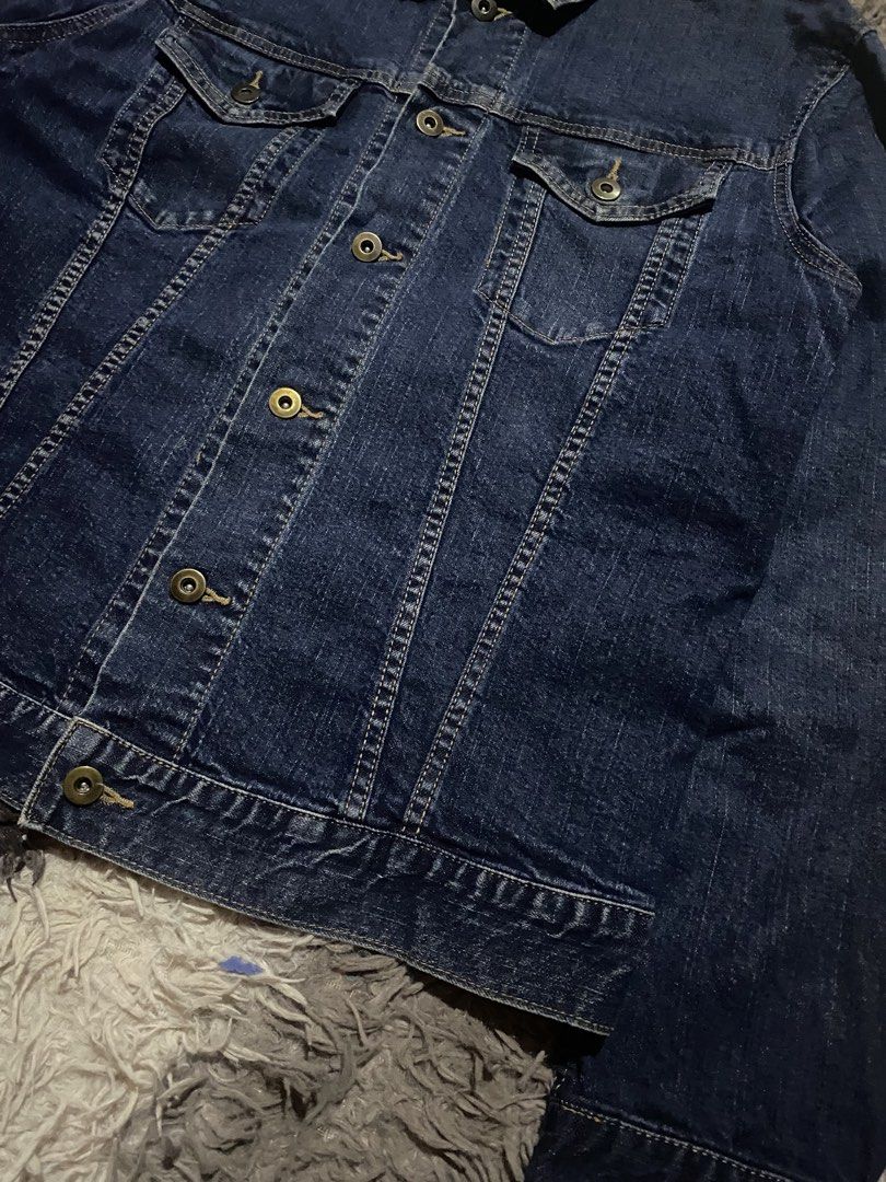 Uniqlo Dark Blue Denim Jacket fit medium (Category: Coats, Jackets and Outerwear) located in Manila. Submitted by coollion.19b40f (Listing ID 1466279396, Image 2). Description: - Brand: Uniqlo - Color: Dark blue - Size: XL - Material: Sturdy denim - Features: Classic button-up front, chest pockets, and contrast stitching - Condition: Great, no major flaws - Origin: Made in China - Style: Versatile outerwear, perfect for layering.