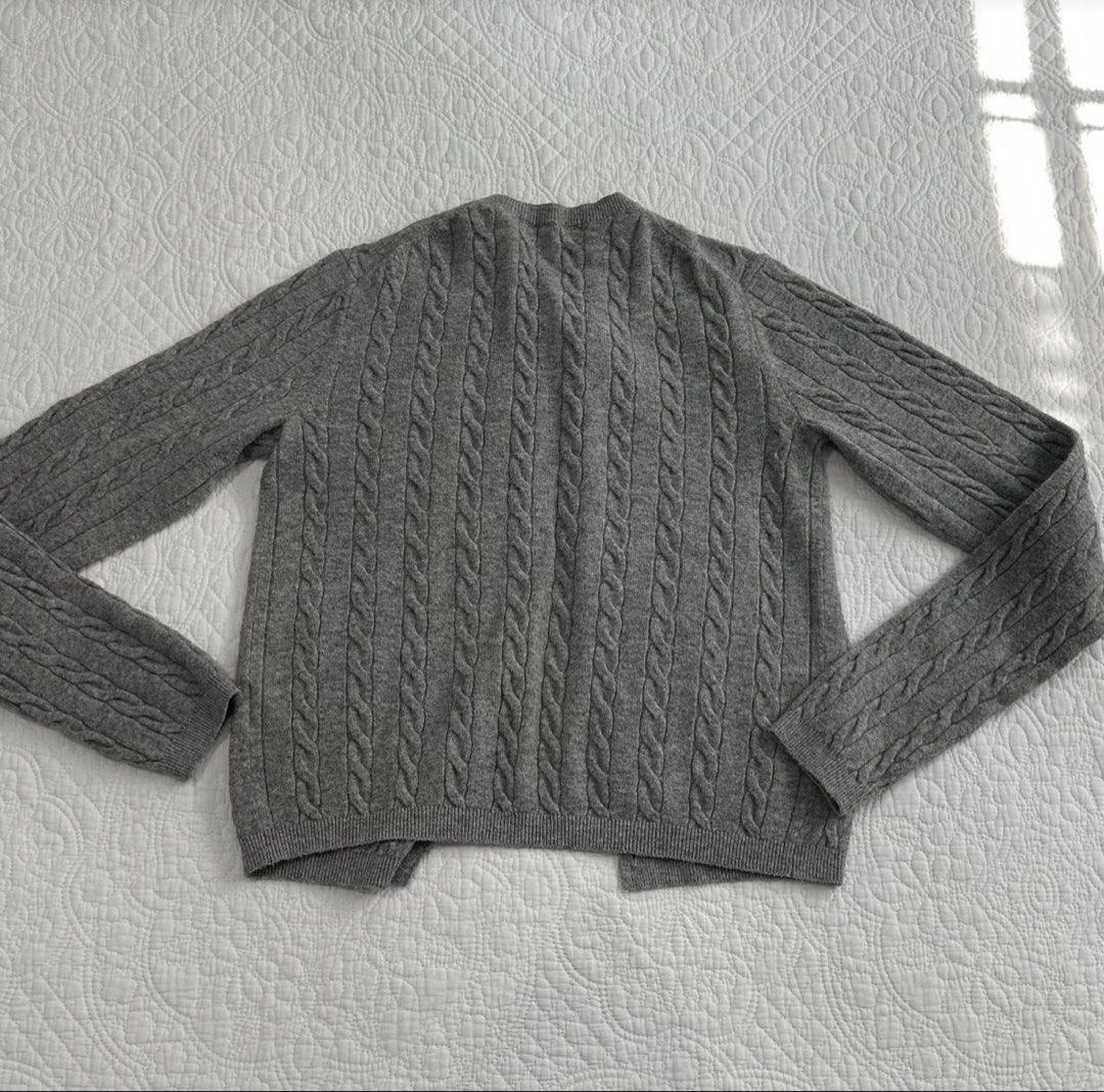 Uniqlo Grey Cable Knit Button Cardigan Jacket (Category: Coats, Jackets and Outerwear) located in Manila. Submitted by hiddentreasureph (Listing ID 1466175315, Image 2). Description: - Brand: Uniqlo - Color: Classic Grey - Material/Style: Cable knit texture with front button closure - Design: Crewneck with ribbed hem and cuffs - Fit: Great layering piece for chilly days.