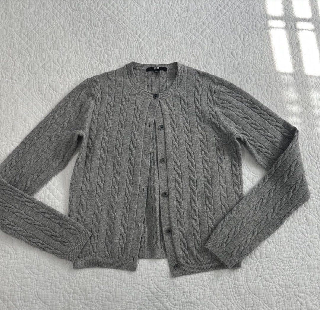 Uniqlo Grey Cable Knit Button Cardigan Jacket (Category: Coats, Jackets and Outerwear) located in Manila. Submitted by hiddentreasureph (Listing ID 1466175315, Image 1). Description: - Brand: Uniqlo - Color: Classic Grey - Material/Style: Cable knit texture with front button closure - Design: Crewneck with ribbed hem and cuffs - Fit: Great layering piece for chilly days.