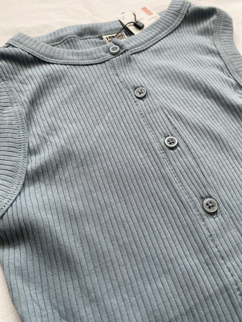 Uniqlo Ribbed Button Front Tank Top Blue Size L (Category: Sleeveless) located in Valenzuela. Submitted by mandies_25 (Listing ID 1466277290, Image 2). Description: - Brand: Uniqlo - Condition: Brand new with original store tags attached - Size: XS - Color: Light blue with matching grey buttons - Material: Soft, stretchy cotton fabric - Design: Scoop neckline, sleeveless, and button-down front closure - Style: Simple basic piece, perfect for ever