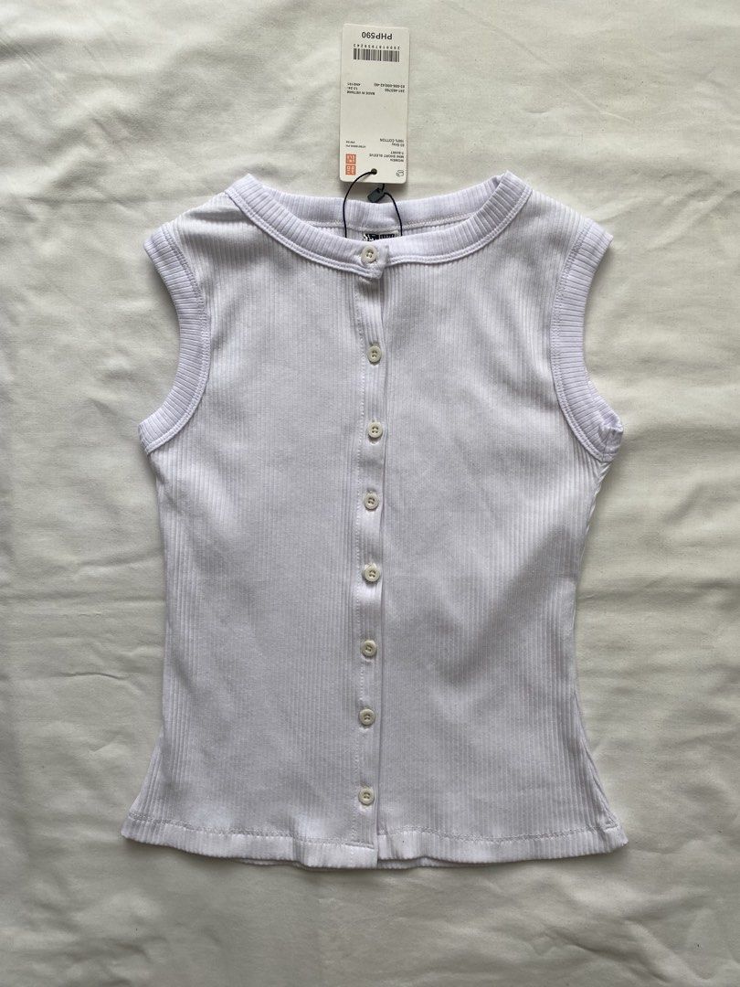 Uniqlo Ribbed Button-Front Sleeveless Top White (Category: Sleeveless) located in Valenzuela. Submitted by mandies_25 (Listing ID 1466282229, Image 1). Description: - Brand: Uniqlo - Color: White - Style: Sleeveless ribbed top with full button-front design and crew neckline - Fit: Fitted, soft, and stretchy - Material: 100% cotton - Condition: Brand new with tags, never worn, super clean - Original Retail Price: PHP590 - Size: S.