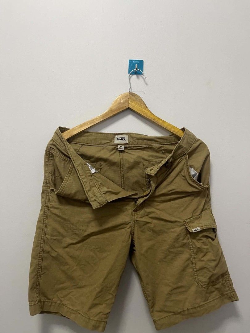 Vans Khaki Cargo Shorts Size 18 (Category: Shorts) located in Manila. Submitted by gregorioju41138 (Listing ID 1466262323, Image 1). Description: - Brand: Vans - Color: Khaki - Size: 30 (Tag inside waistband) - Material: 100% Cotton with unique grid texture - Closure: Button closure with zip fly - Pockets: Multiple side and back pockets, including buttoned back pockets and a small side cargo pocket - Details: Signature woven Vans label on the bac